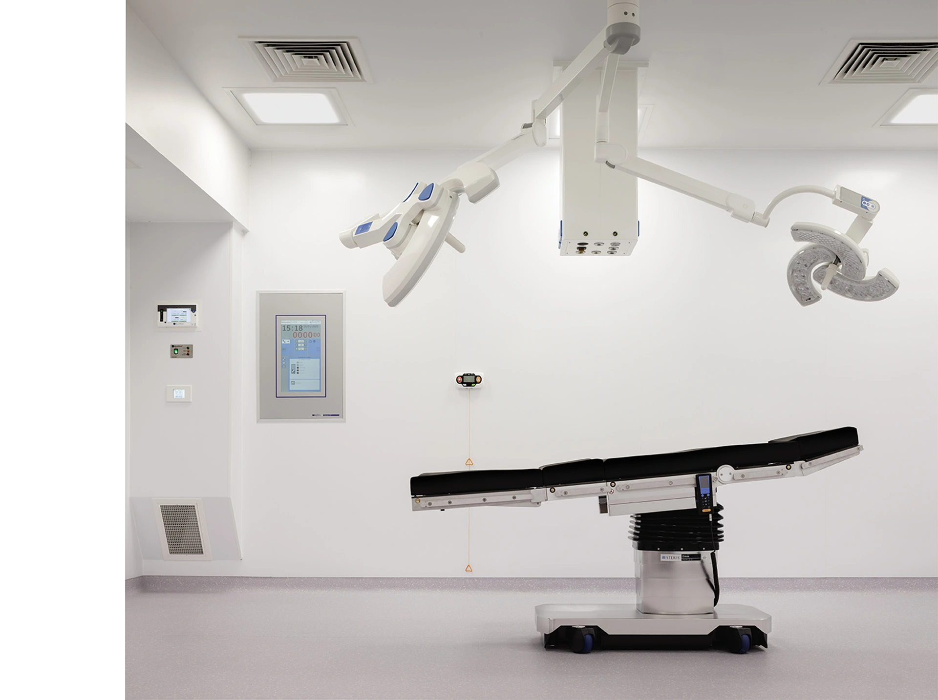 State-of-the-art operating theatre in Glasgow's Elanic Hospital with modern equipment, operating chair in the middle and all white walls and ceiling, and protective special medical premises vinyl flooring.