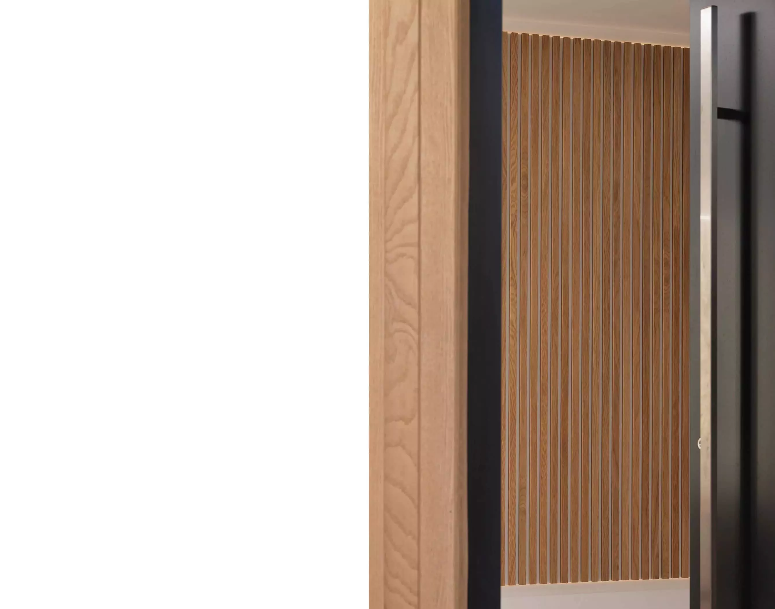 Interior view of a modern house extension by Glasgow architects, showcasing sleek vertical wooden panelling in an open-plan entrance area. The space is enhanced by natural light, a white colour palette, and subtle LED lighting integrated into the design. This contemporary renovation and remodelling project features a minimalist approach, with emphasis on clean lines and textures that contribute to a warm and inviting interior design.